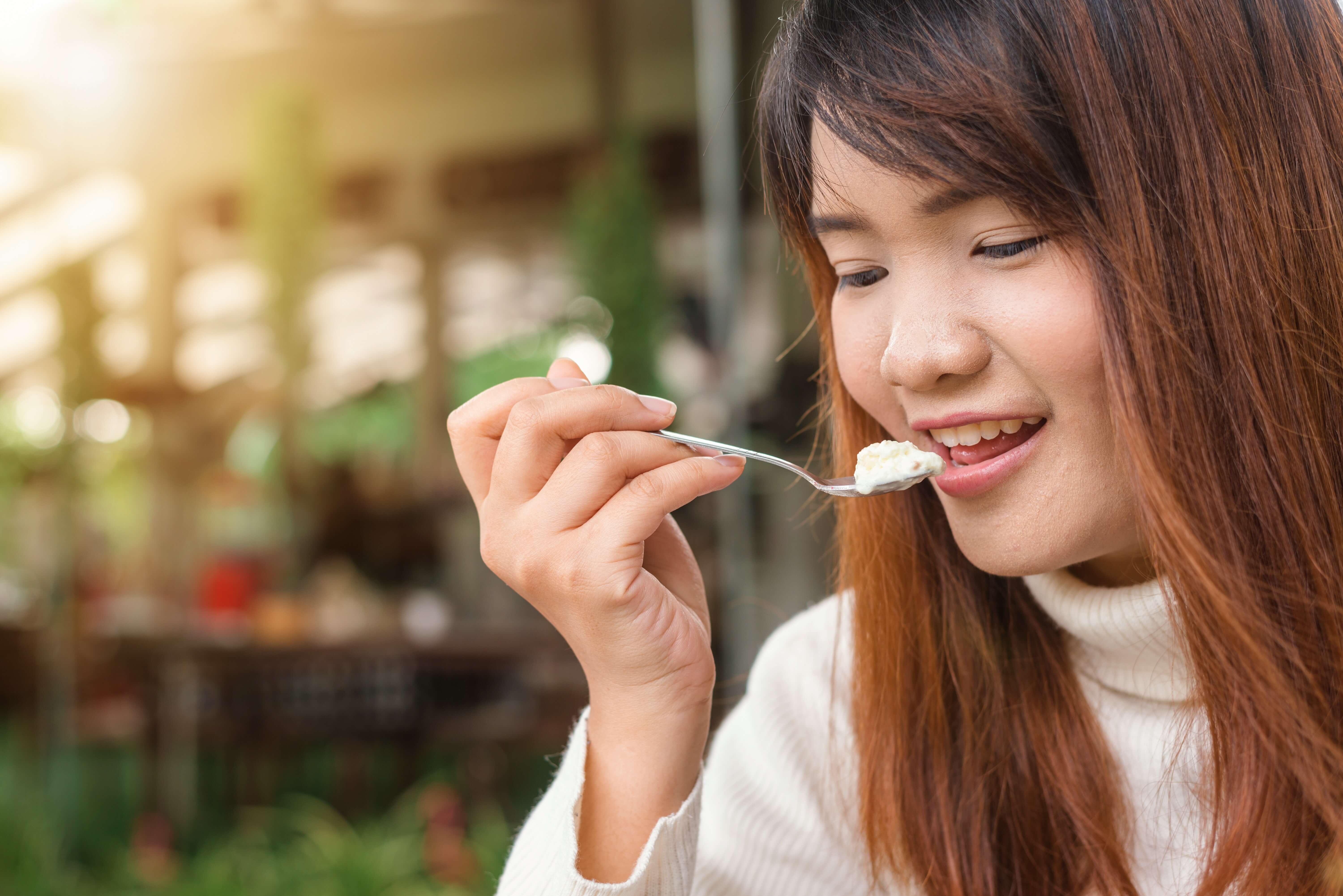 woman-holding-spoon-trying-to-eat-white-food-733851 (1).jfif